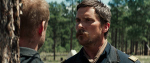 John Benjamin Hickey as Capt. Royce Tolan (left) with Christian Bale as Capt. Joseph Blocker (right) 